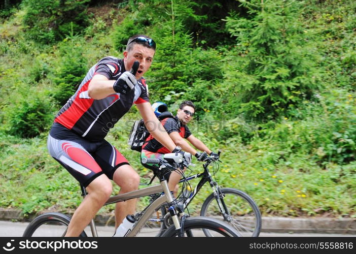 two friends have fun outdoor in nature and representing concept of healthy life and fitnes on muntain bike