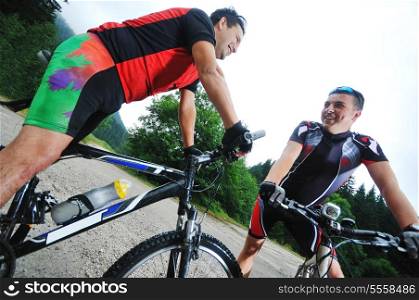 two friends have fun outdoor in nature and ride on muntain bike