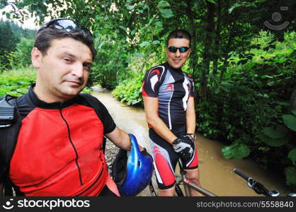 two friends have fun outdoor in nature and ride on muntain bike