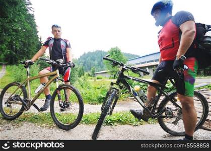 two friends have fun outdoor in nature and ride on muntain bike