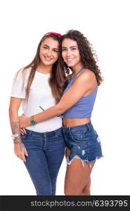 Two friends posing in studio isolated over a white background