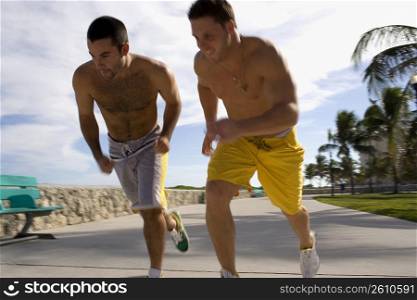 Two friends race each other at the beach