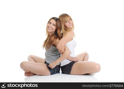 Two friends sitting on the floor. Isolated on white background