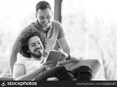 Two friends taking selfie with tablet