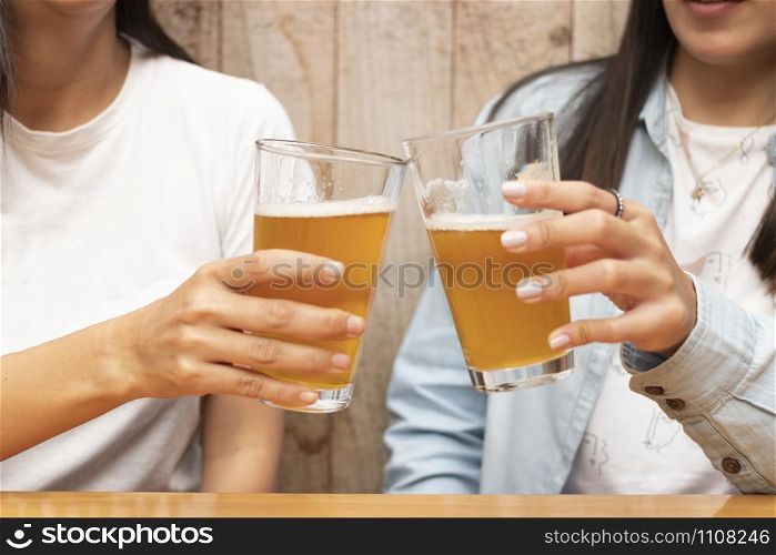 Two friends toasting with beers