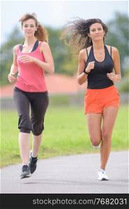 two friends women are jogging