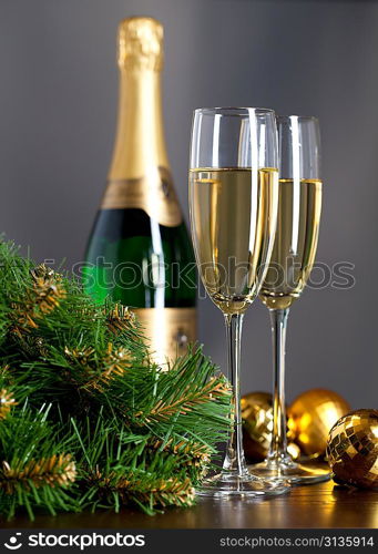 Two full glasses of champagne over color background