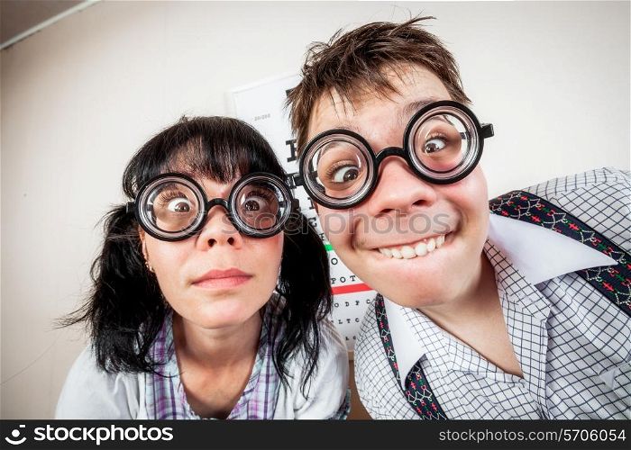 Two funny person wearing spectacles in an office at the doctor
