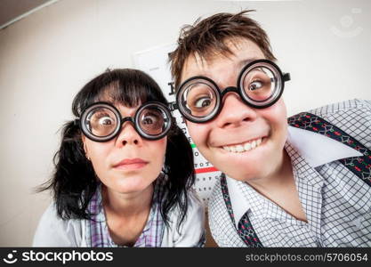 Two funny person wearing spectacles in an office at the doctor