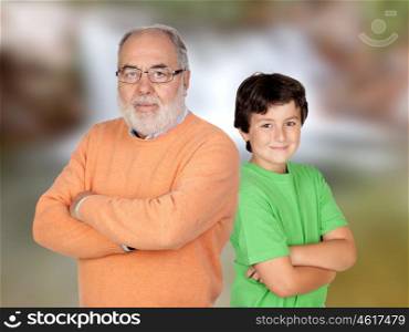 Two generations, grandfather and grandson with crossed arms and unfocused background