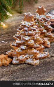 two gingerbread christmas tree cookies on wooden background. gingerbread christmas tree