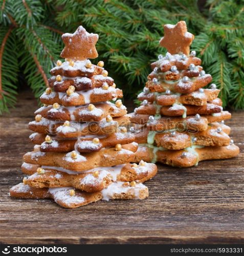 two gingerbread christmas tree with evergreen twing