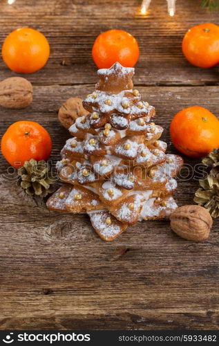 two gingerbread tree tangerines on wooden background. gingerbread christmas tree