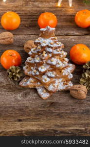 two gingerbread tree tangerines on wooden background. gingerbread christmas tree