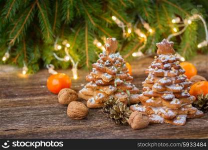 two gingerbread tree with christmas lights in background