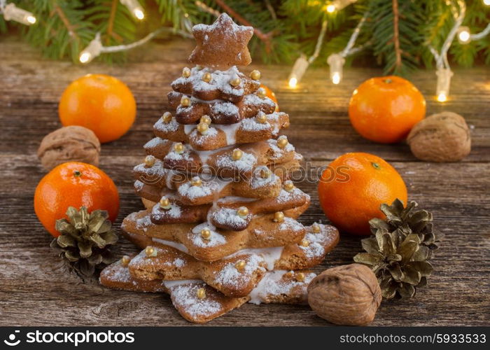 two gingerbread tree with fresh tangerines on wooden background. gingerbread christmas tree