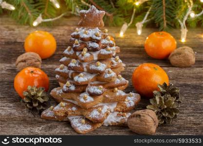two gingerbread tree with fresh tangerines on wooden background. gingerbread christmas tree