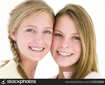 Two girl friends together smiling