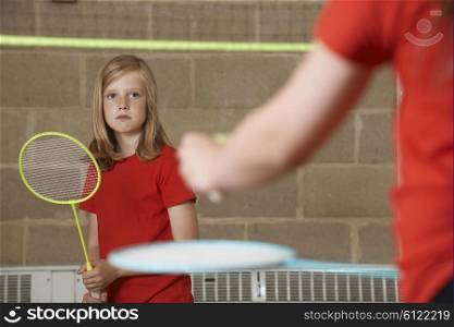 Two Girl Playing Badminton In School Gym