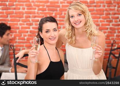two girlfriends drinking champagne