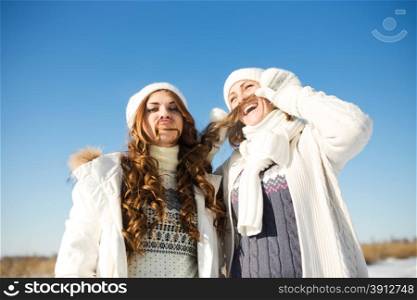 Two girlfriends have fun at beautiful winter day