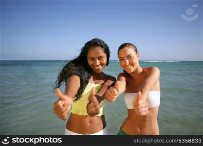 two girlfriends having fun on the beach