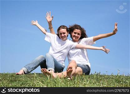 Two girlfriends in white T-shorts have waved hands