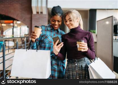 Two girlfriends makes selfie in shop, shopping. Shopaholics in clothing store, consumerism lifestyle, fashion. Two girlfriends makes selfie in shop, shopping