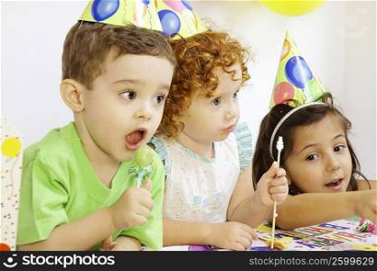 Two girls and a boy at a birthday party