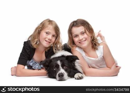 Two girls and a dog. Two girls and a dog lying on front