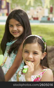 Two girls at a birthday party in a park