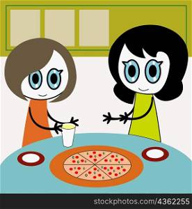 Two girls at a table with a pizza