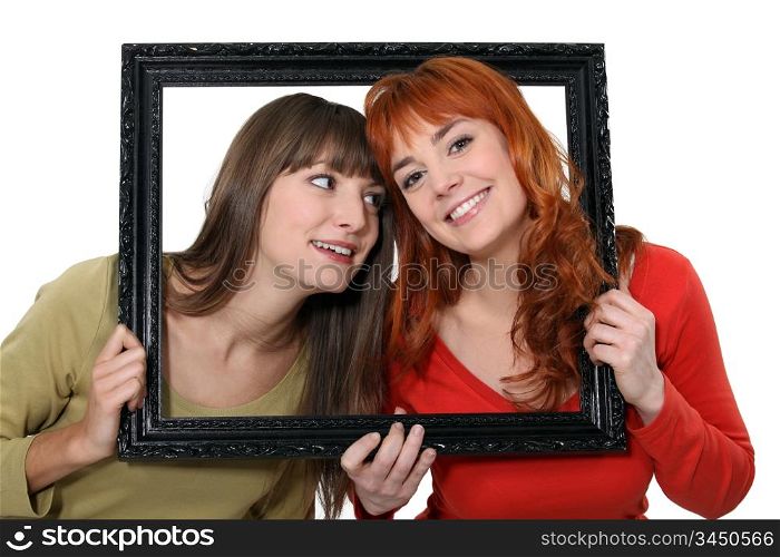 Two girls behind black frame