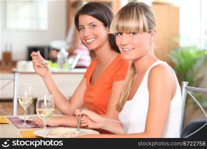 Two girls eating in the kitchen