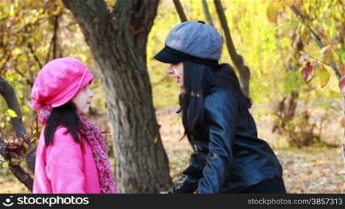 Two girls fighting angry in autumn forest