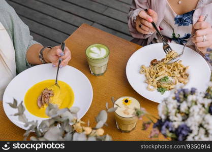 two girls have lunch in a restaurant