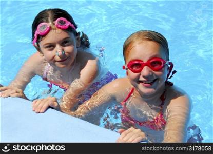 Two girls having fun in a swimming pool
