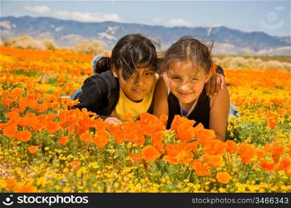 Two Girls Laying In Poppy Field