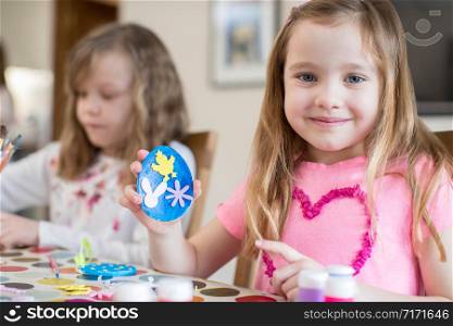 Two Girls Making Easter Decorations At Home