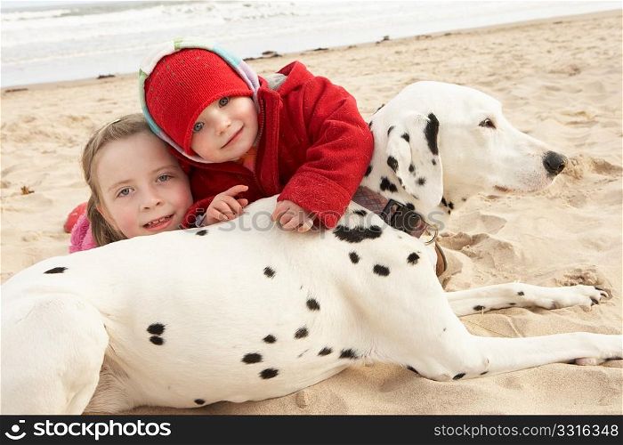 Two Girls On Beach With Pet Dog