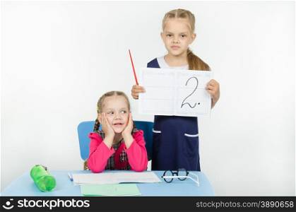 Two girls play school teacher and student. Pupil reacted indifferently to another deuce