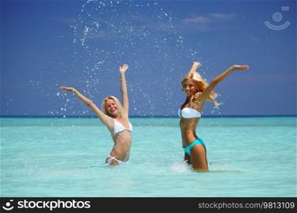 Two girls playing in ocean water