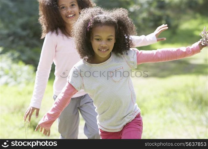 Two Girls Playing In Woods Together