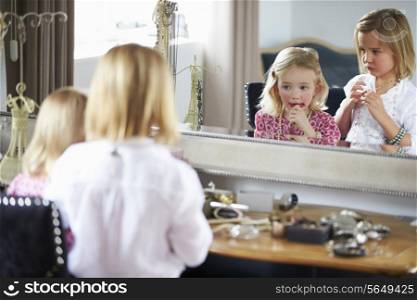Two Girls Playing With Jewelry And Make Up