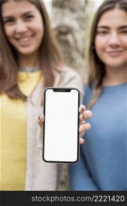 two girls presenting smartphone mockup