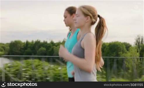 Two Girls Run Along the Walkway at Park Next to a Beautiful Lake. 2 plans in 1 pack