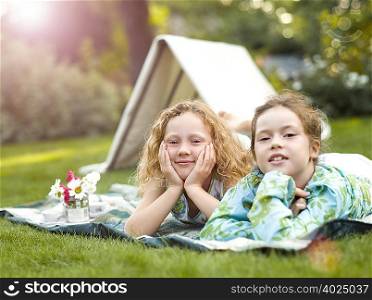 Two girls smiling at play picnic