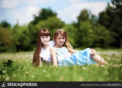 two girls spending time together in the summer park