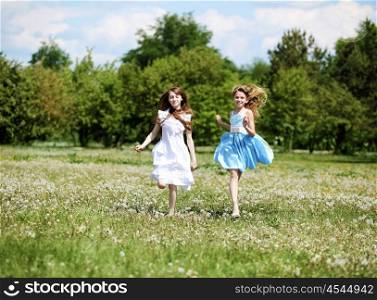 two girls spending time together in the summer park