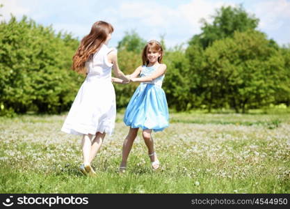 two girls spending time together in the summer park